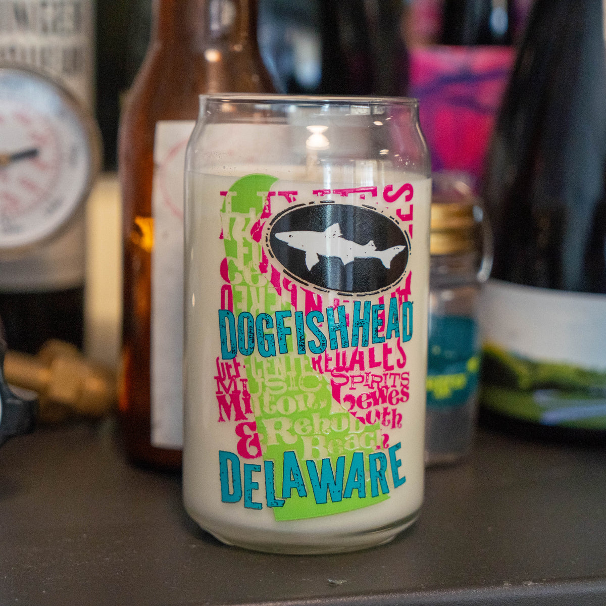 Delaware Grunge Can Glass Candle shaped like a can, featuring a white wax fill and a graphic logo that includes a shark silhouette and the text Delaware.