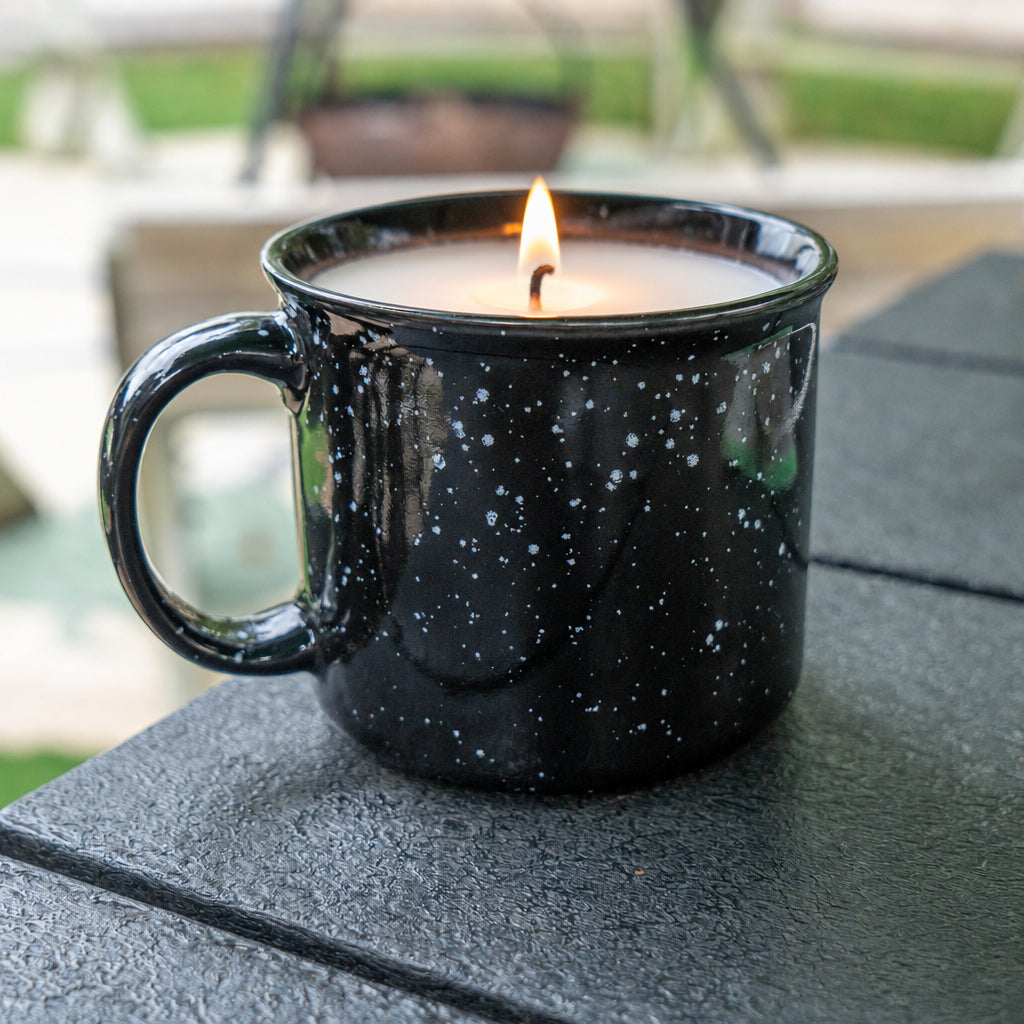 Black speckled mug sitting on table.