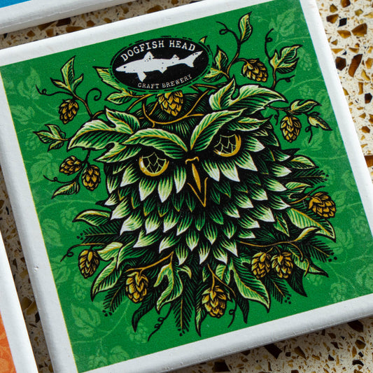 Season-Ale Artist Series Coaster Set featuring a square coaster with an illustration of an owl made of green hop leaves, topped with a Dogfish Head Craft Brewery logo.
