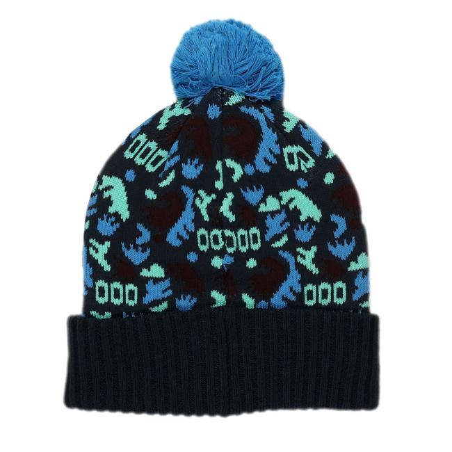 The Patagonia Black and Blue Pom Beanie by Patagonia features teal and blue shapes on a dark recycled polyester knit, a blue pom-pom, and a black ribbed fold-over brim—offering style, warmth, and sustainability.