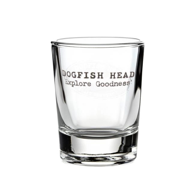 A clear 2.5 oz Shot Glass by Grandstand Glassware & Apparel with "DOGFISH HEAD Explore Goodness" in black text—ideal for spirits and collectors of Dogfish Distilling Co. shot glasses.