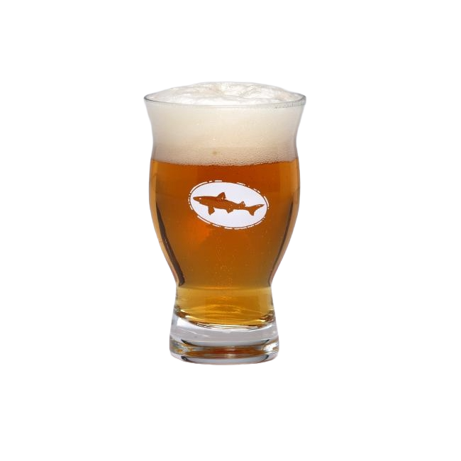 A Grandstand Glassware & Apparel 5oz Revival Tasting Glass filled with golden amber beer and a thick, foamy head, featuring the logo with a shark in an oval on the front. The glass is set against a plain white background.