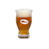 A Grandstand Glassware & Apparel 5oz Revival Tasting Glass filled with golden amber beer and a thick, foamy head, featuring the logo with a shark in an oval on the front. The glass is set against a plain white background.