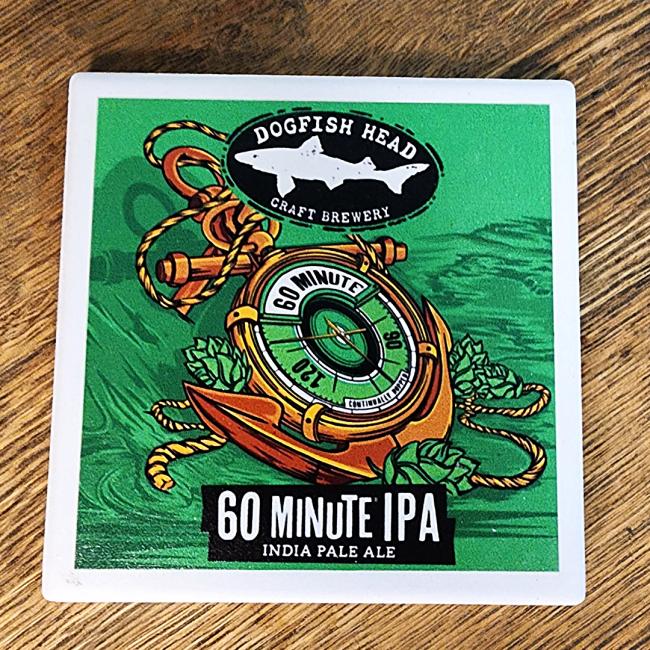 The 60 Minute Ceramic Coaster by Paint the Town, Inc. features a green background with nautical artwork—a stopwatch wrapped in hops and rope—and the text “60 Minute IPA” and “India Pale Ale” at the bottom.