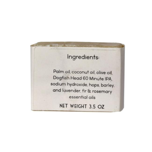 A 3.5 oz bar of Parsonage Handmade Soaps Beer Soap featuring ingredients like palm, coconut, and olive oils, Dogfish Head 60 Minute IPA, hops, barley, sodium hydroxide, plus lavender, fir & rosemary essential oils.