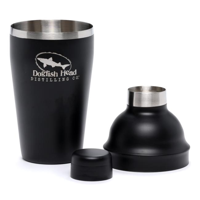 Black cocktail shaker featuring white Dogfish head shark and shield logo on the front with writing "Distilling Co." underneath.