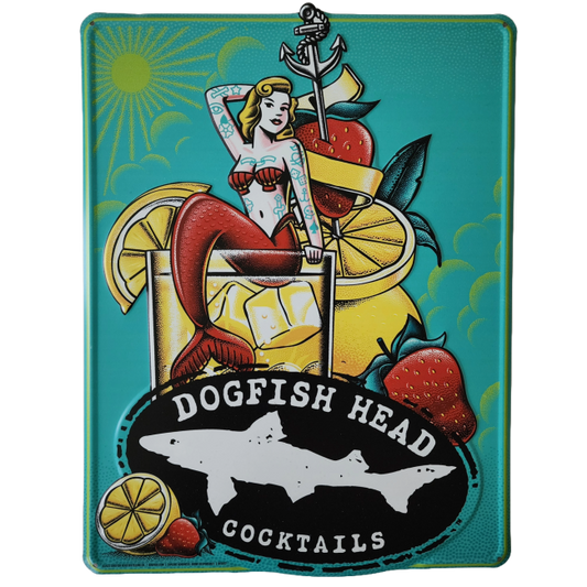 A vintage-style Canned Cocktails Tin Tacker by Merchtank features a tattooed mermaid in a cocktail glass with ice and fruit. "Canned Cocktails" text appears above a shark silhouette logo—perfect nautical wall decor.