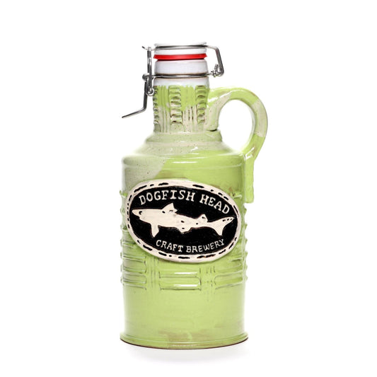 The Citrus Green Ceramic Growler by Romanick Pottery features a handle, flip-top lid, and a raised black and white oval Dogfish Head Craft Brewery logo with a shark illustration.