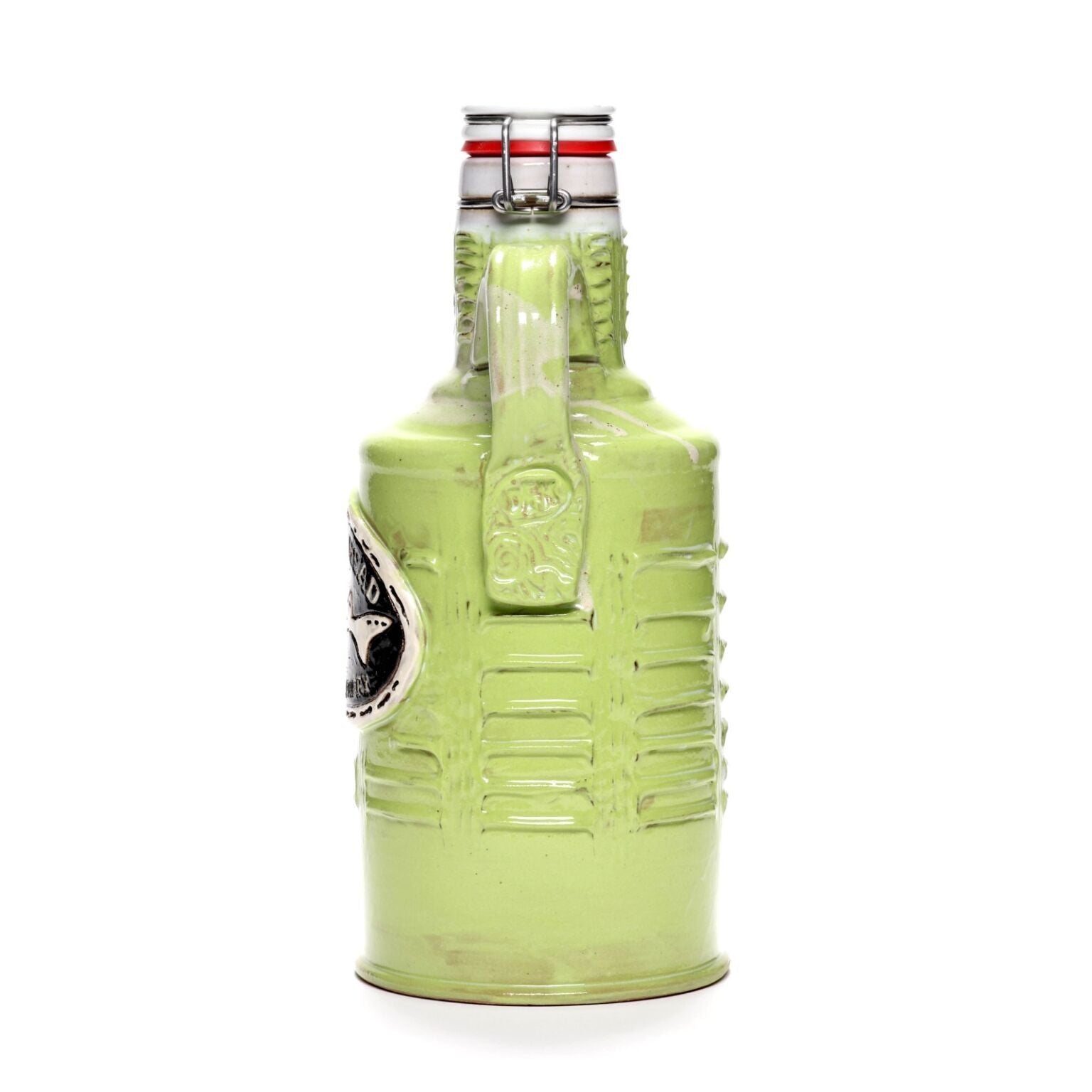 The Citrus Green Ceramic Growler by Romanick Pottery, hand crafted with a handle, metal clasp lid, and silver emblem on the side, stands upright against a white background.