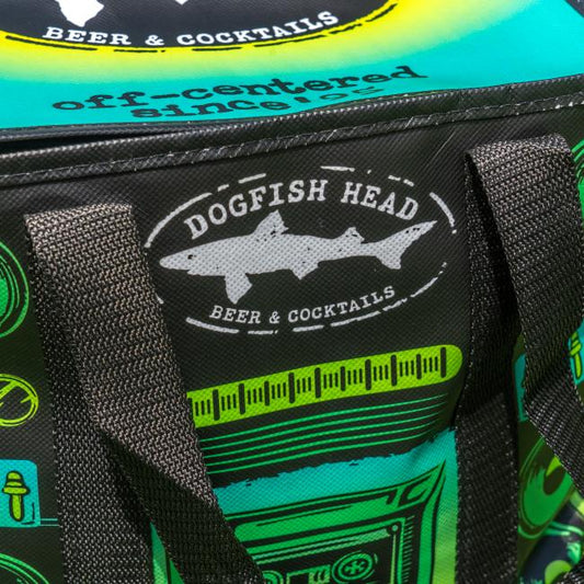 Close-up of a vibrant Go Match Up Cooler Bag with black handles and bold green, blue, and yellow graphics. The insulated soft cooler features the Beer & Cocktails logo with a shark silhouette, combining function and striking style.