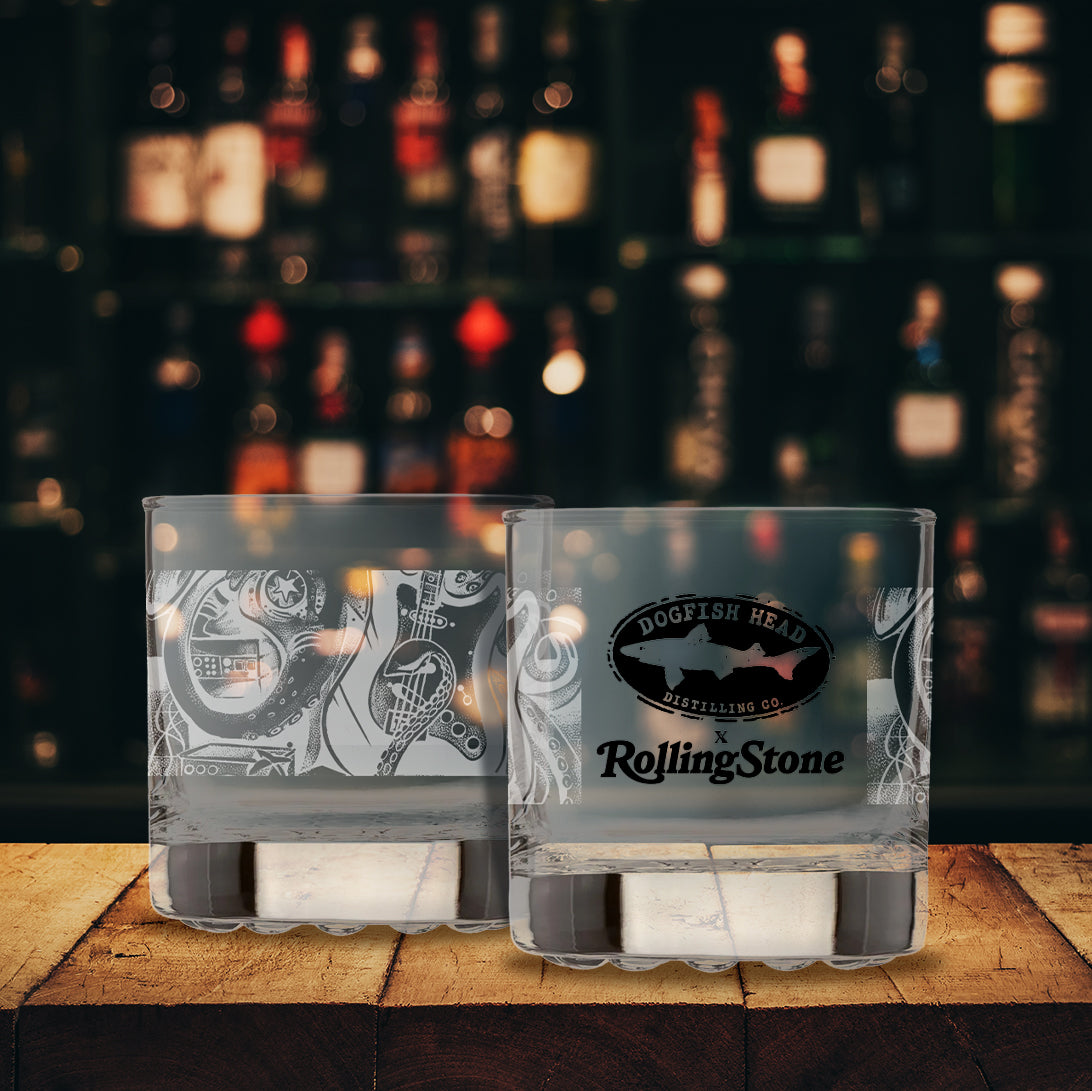 Two clear glasses with Dogfish Head and Rolling Stone logos on a blurred out background
