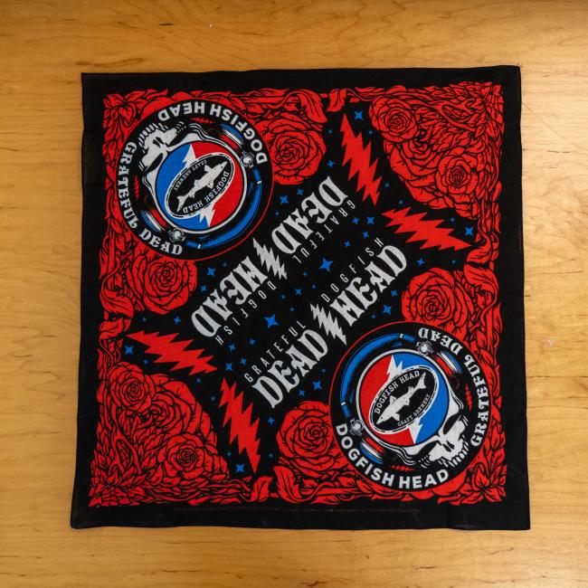 The Merchtank Dogfish Head x Grateful Dead Bandana features logos, red roses, blue stars, and red lightning bolts on black—a perfect craft beer accessory for fans.