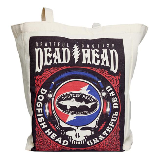 The Dogfish Head x Grateful Dead Tote Bag by Red Promotions features a beige design with a skull wearing headphones and circular logo—ideal craft beer merch for any Grateful Dead fan.