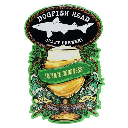 The Merchtank Explore Goodness Beer Tin Tacker features a shark silhouette above a beer glass, accented by hops and waves, with a green "Explore Goodness" ribbon and Milton, Delaware at the bottom.