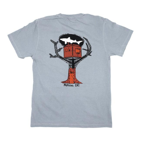 The GO WEST T-SHIRT COMPANY Granite Treehouse Short Sleeve Tee is crafted from soft ring spun cotton and features a red treehouse graphic in a black tree silhouette, a white shark above, and Milton, DE printed below for a true Milton vibe.
