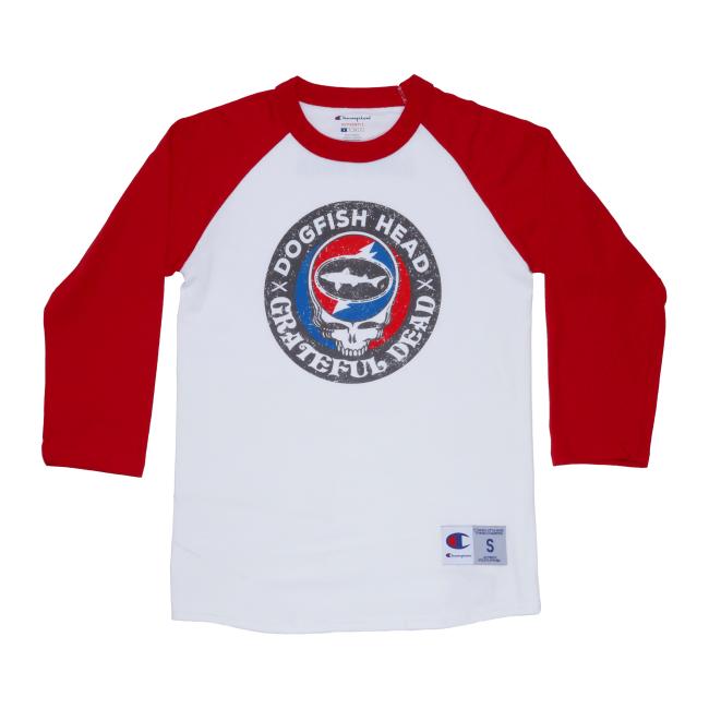 White three quarter sleeve tee with red sleeves. Tee has a black emblem on the center with "Dogfish Head" "Grateful Dead" written around the circle. White skull is featured in the center wearing blue and red headphones. In the head of the skull is a black Dogfish Head shark and shield logo with the background of a circle which is half red and half blue with a white lightning bolt going through it. Champion logo featured on the bottom of the left sleeve and on the bottom left of the body of the tee.