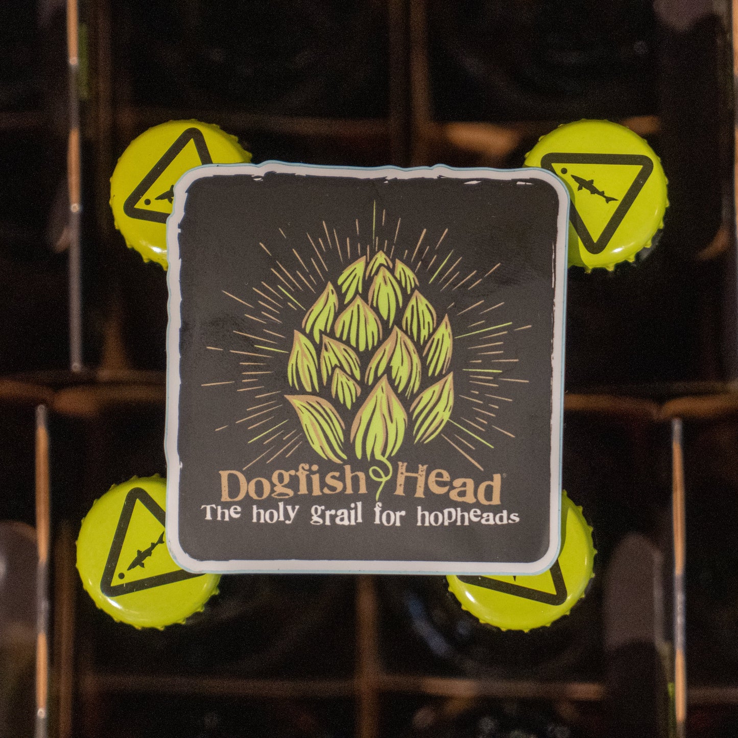 Black sticker with green hophead logo on it. With writing "Dogfish Head" and "The holy grail for hopheads" underneath.