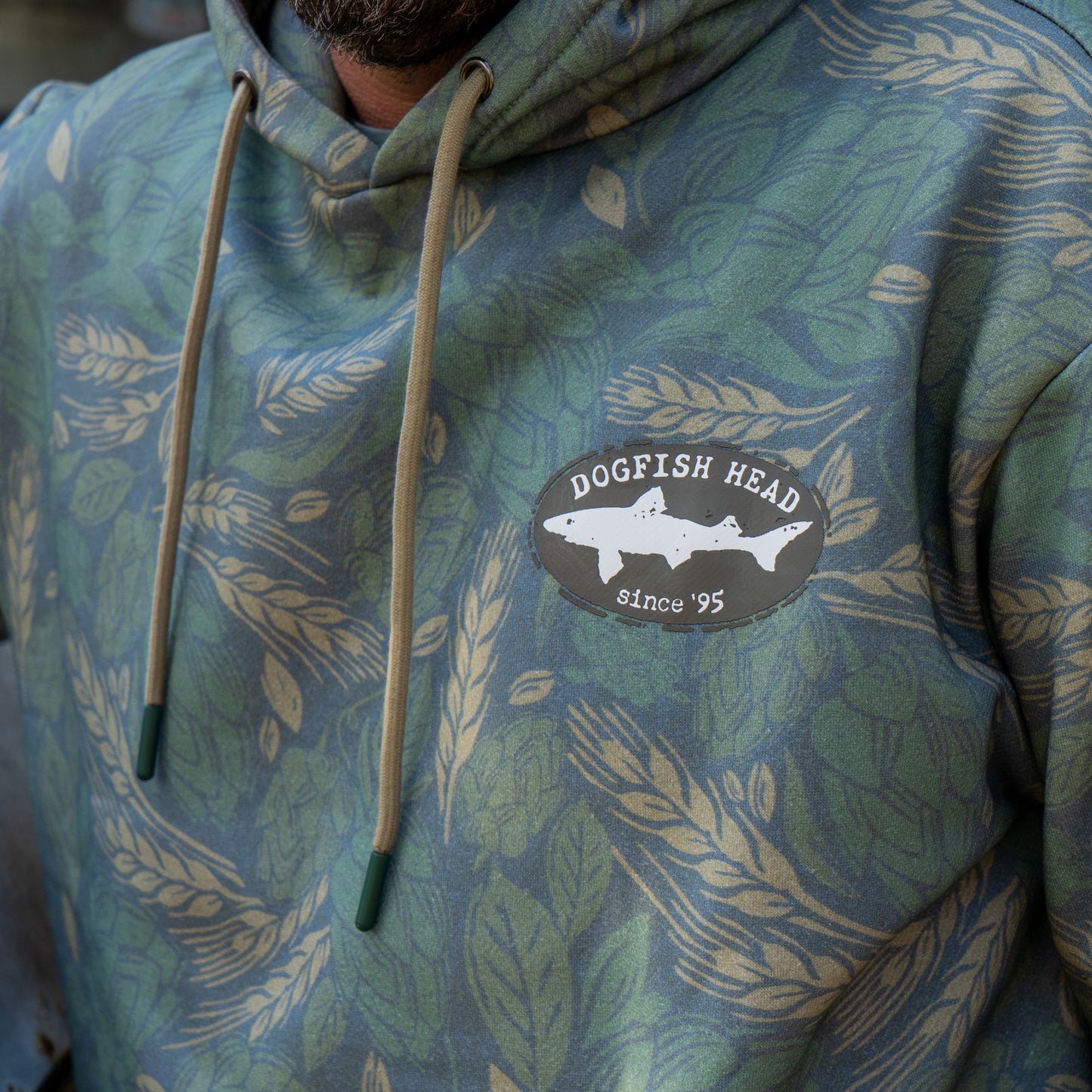 Close up of the black Dogfish Head shark and shield logo that is featured on the left side of the chest.