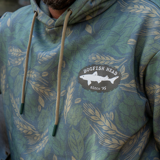 Close up of the black Dogfish Head shark and shield logo that is featured on the left side of the chest.