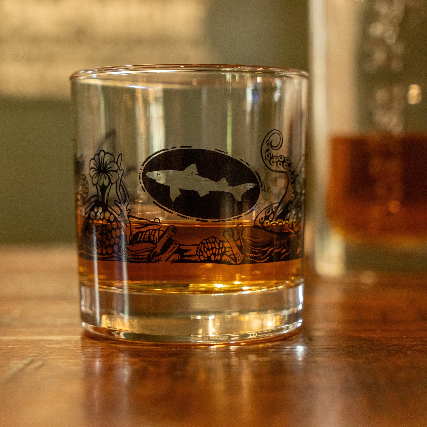 Enjoy your favorite pour with the Hull and Helm Rocks Glass by Grandstand Glassware & Apparel, featuring a fish-inspired design.