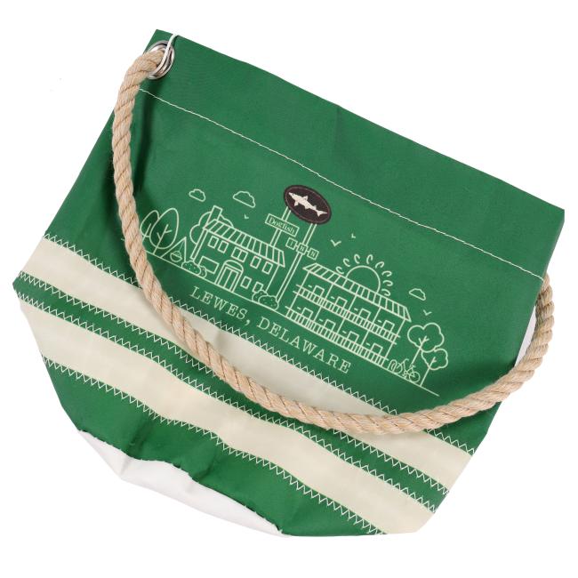 The Seabags INN Seabag Bucket Bag is a green and white recycled sail tote with a thick rope handle, featuring a line drawing of buildings and trees, and “Lewes, Delaware” printed below the illustration.