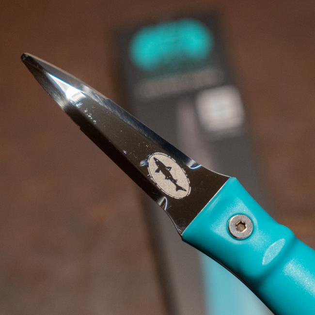 Blue oyster knife features the Dogfish Head shark and shield logo engraved on one side of the knife. The other side of the knife features the Toadfish logo engraved. 