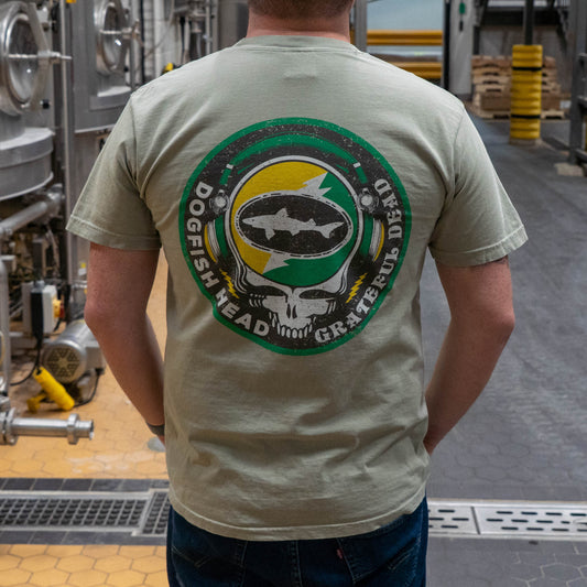 Backside of Dogfish Head x Grateful Dead Citrus Daydream Short Sleeve Sand colored tee. The backside has a large Dogfish Head x Grateful Dead Logo in citrus orange and Dogfish Head green. 