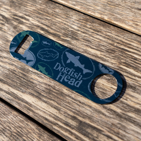 Blue bottle opener with 'Dogfish Head' branding on a wooden surface