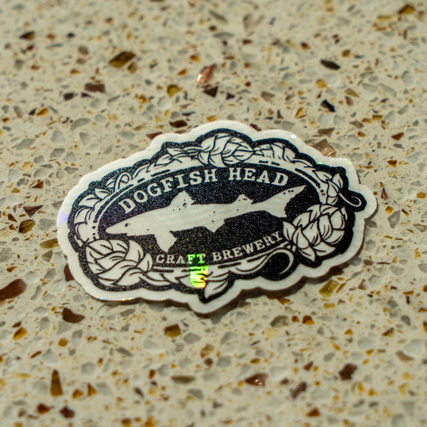 Dogfish Head Craft Brewery sticker on a textured surface
