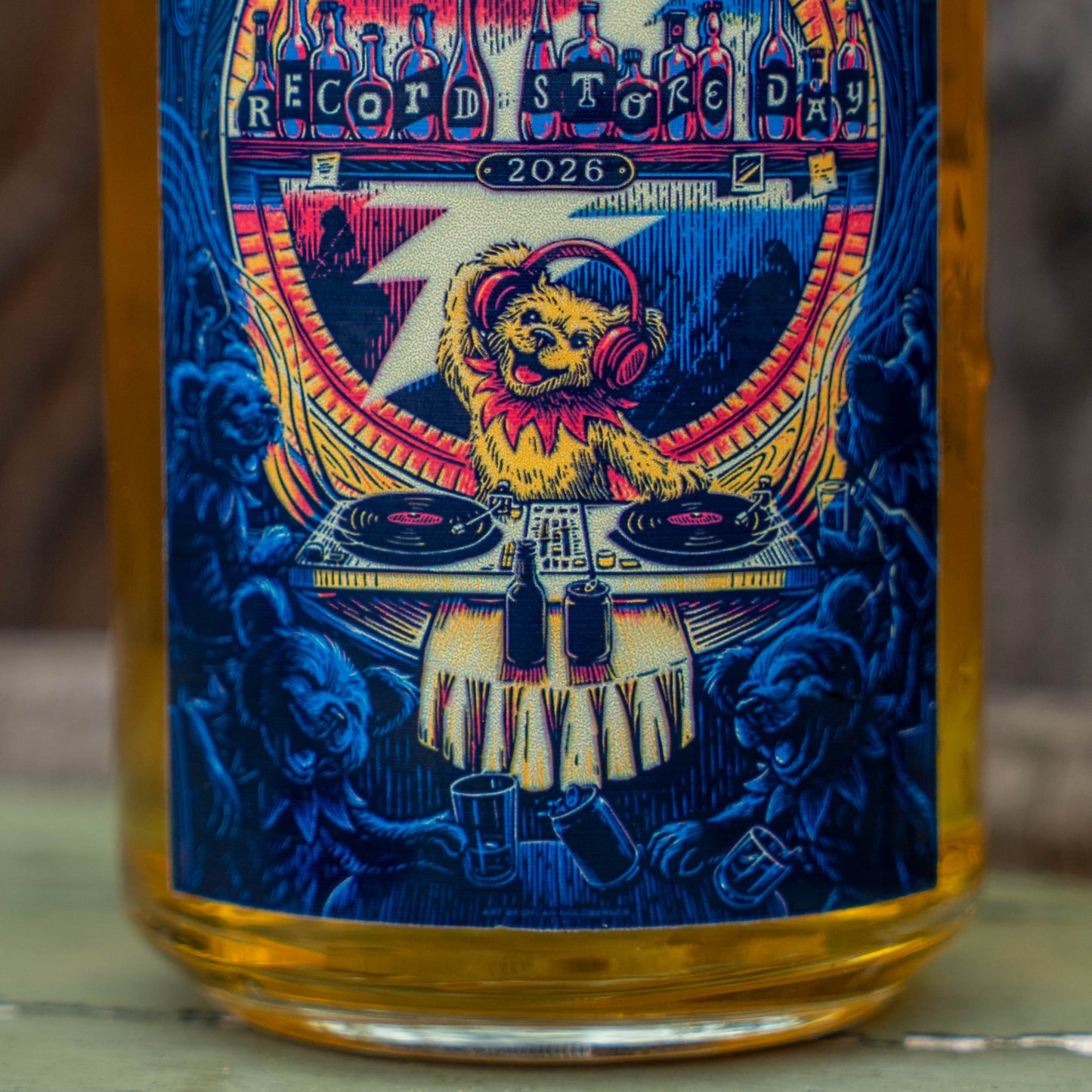 Close-up of Record Store Day 2026 artwork on Dogfish Head x Grateful Dead can glass featuring bear DJ and vinyl turntables