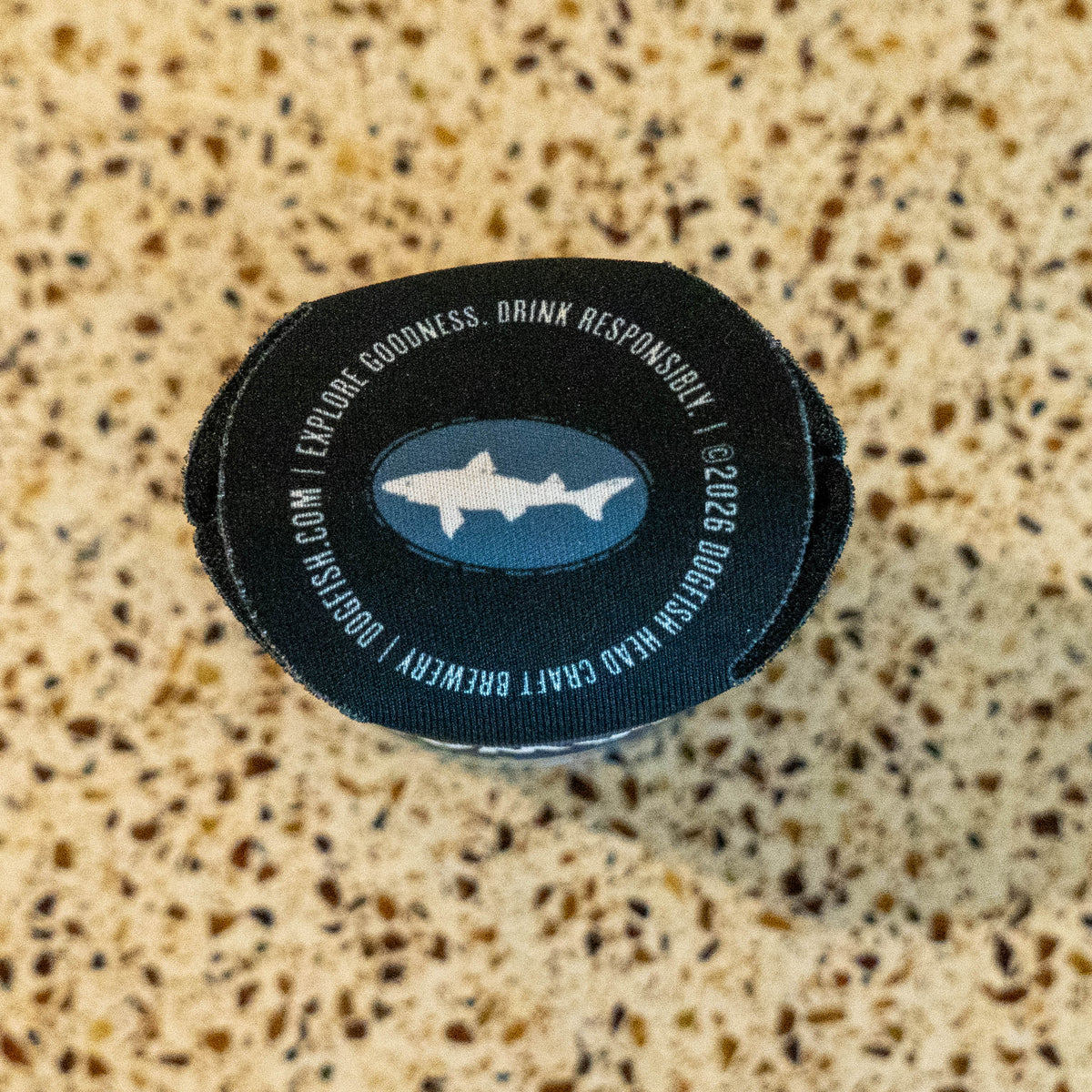 Bottom of can cooler with dogfish head logo and legal line in a circle.