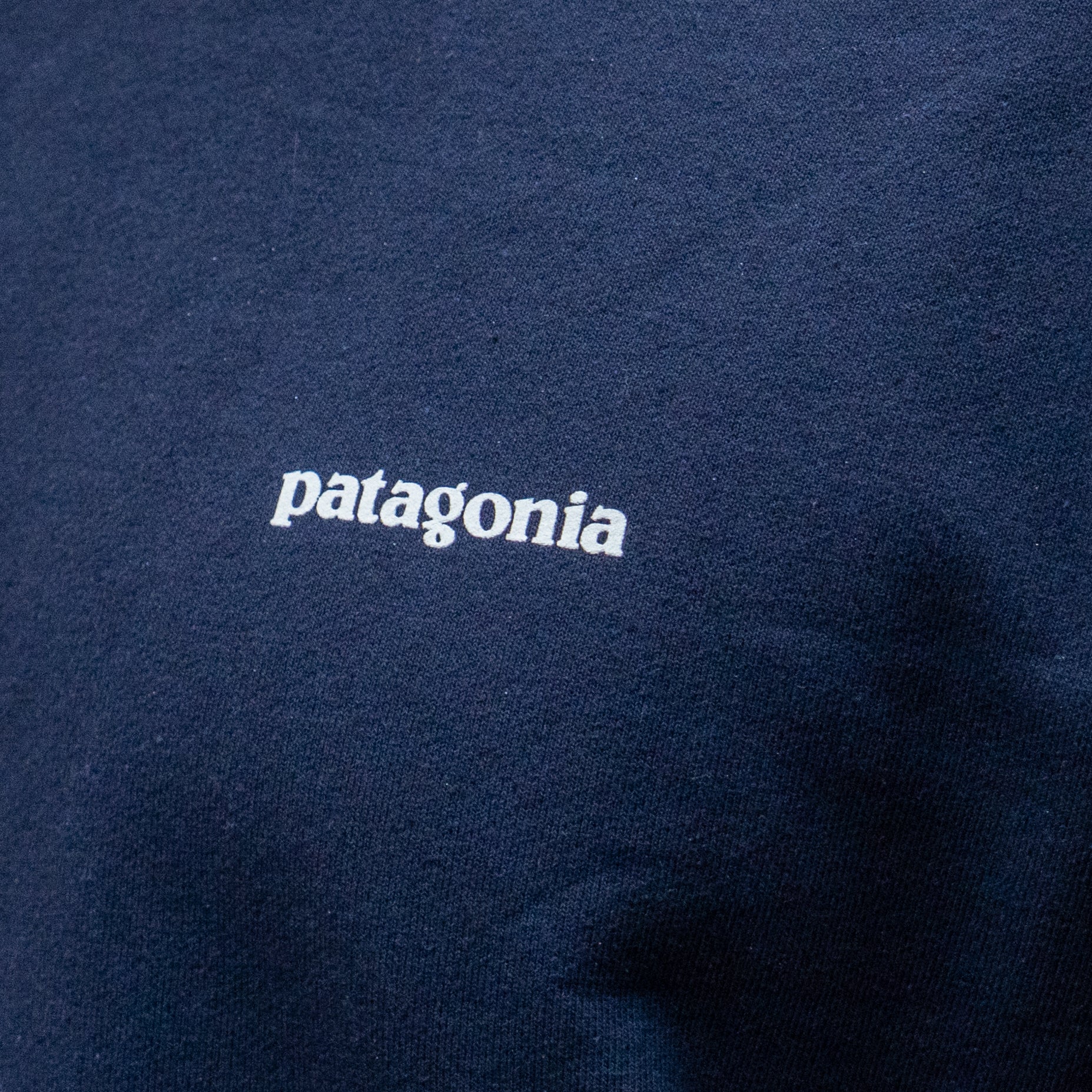 Navy blue fabric with 'patagonia' logo in white