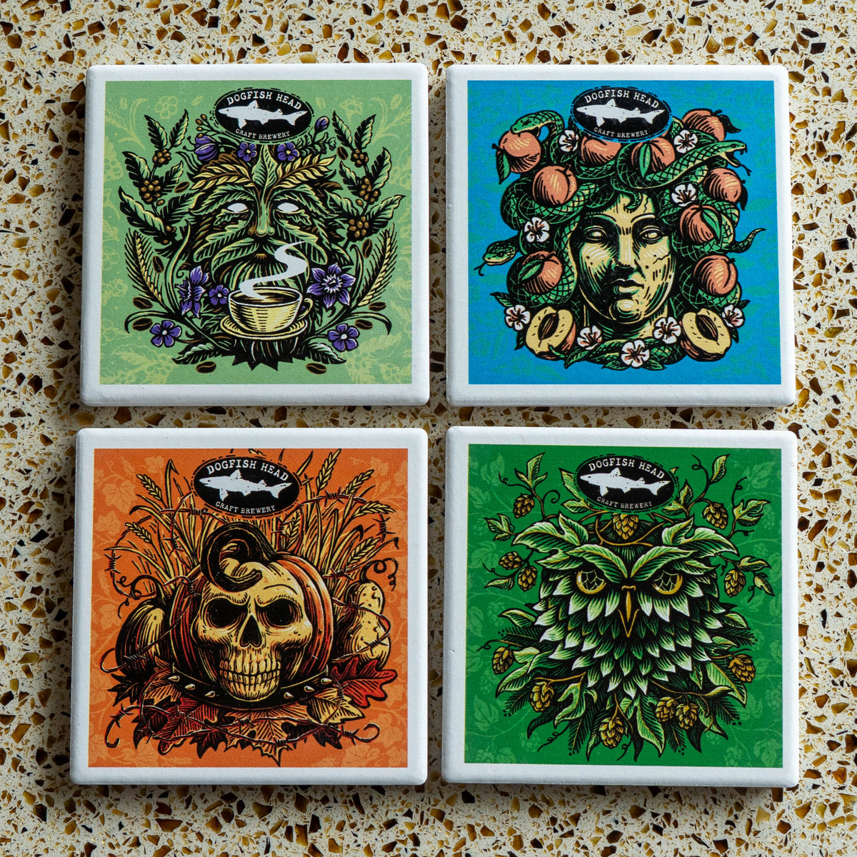 Season-Ale Artist Series Coaster Set featuring four square ceramic coasters with seasonal artwork of a coffee-drinking figure, a peach-crowned goddess, a pumpkin skull, and an owl made of hops.