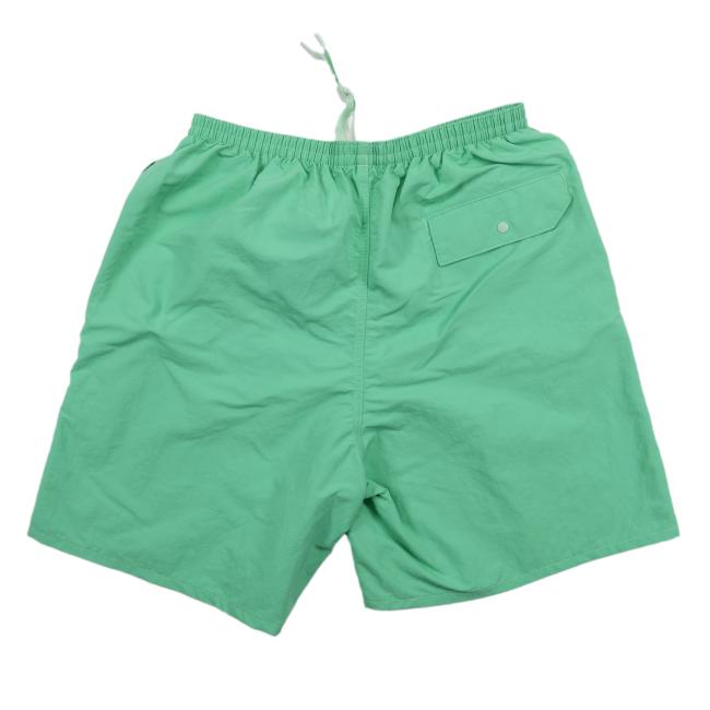 The Patagonia Green Baggies Long Shorts feature quick-drying fabric, an elastic waistband, white drawstring, and a single back pocket with a button flap.