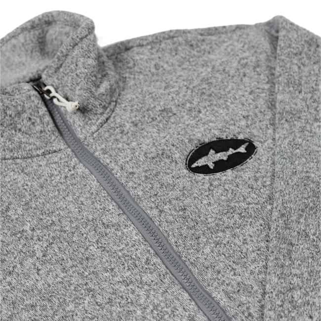 A close-up of the Patagonia W Heather Gray Full Zip Sweater Coat shows the black fish logo on the chest and partially closed zipper, highlighting its cozy, soft recycled polyester fleece with a textured look.