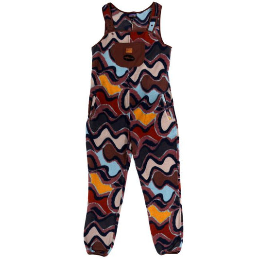 The Patagonia W Multi-Colored Synch Onesie is a recycled polyester fleece overall in blue, yellow, brown, and cream tones with a brown front pocket and shoulder buttons—perfect as a cozy base layer.