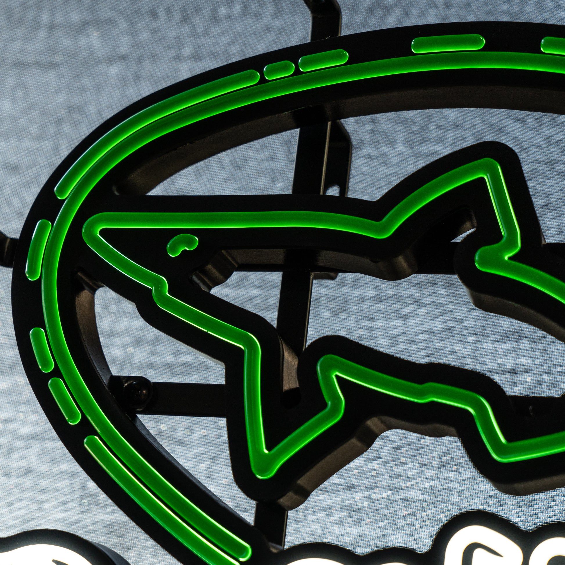 Close‑up of Dogfish Head LED neon light showing glowing green shark logo outline and sleek LED tubing