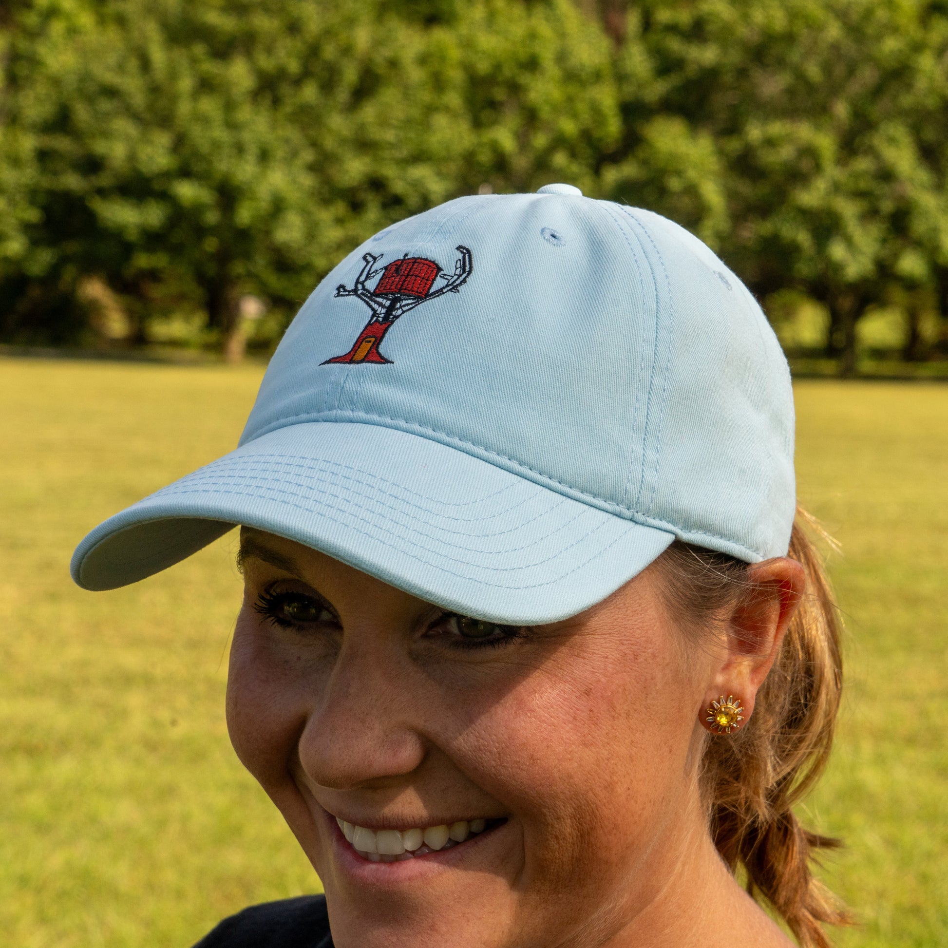 Powder blue hat features imagery of a treehouse centered to the front.