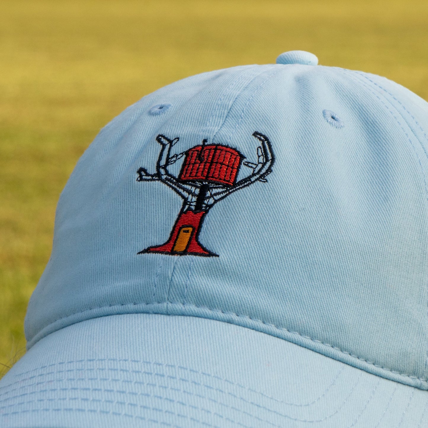 Close-up of the treehouse featured on the front of the powder blue hat.