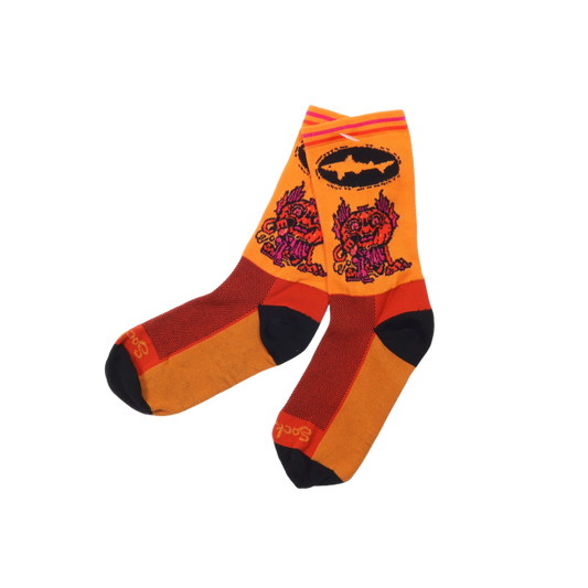 Orange socks that are black at the toes and the heel. This year's Punkin artwork is featured on the body of the sock and the Dogfish Head shark and shield logo in black is right above it.