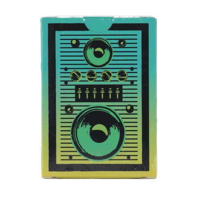 The United States Playing Card Company Retro Stereo Playing Cards feature a retro stereo-inspired design with black speakers and control knobs set on a green and yellow gradient box.
