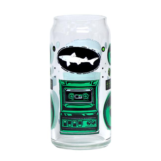The Retro Stereo Tall Boy Can Glass by Grandstand Glassware & Apparel is a clear can-shaped beer glass featuring green and black boombox graphics with a white shark silhouette at the center.