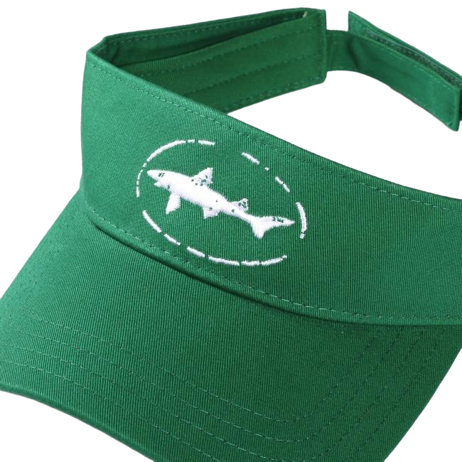 The Shark and Shield Visor by PUKKA features a green design with a white embroidered shark in a dotted oval on the front and an adjustable Velcro closure for a perfect fit.