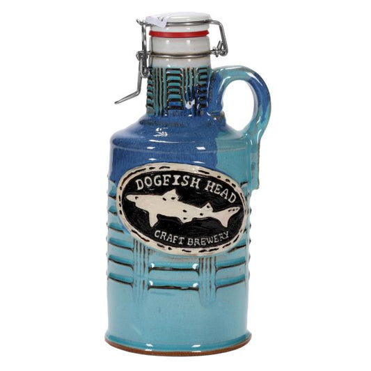 The Tie Dye Ceramic Growler by Romanick Pottery is a blue handcrafted beer growler with a handle and flip-top lid, featuring an oval label with two fish.