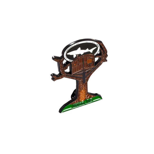 Treehouse Pin by Arrasmith Promotions LLC: brown enamel treehouse with a silver oval bat silhouette atop green ground—a unique accessory perfect for fans and collectors.