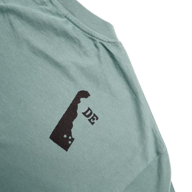 The W Green Delaware Logo Short Sleeve Tee by GO WEST T-SHIRT COMPANY is crafted from soft organic cotton and features a black state silhouette with two stars and "DE" on the upper back.