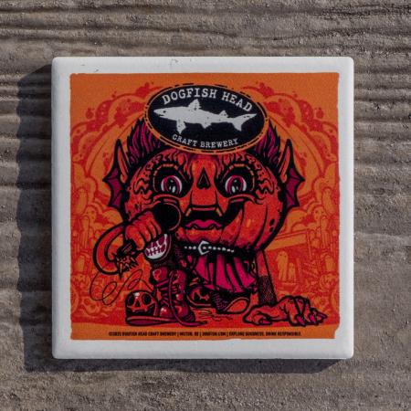 Orange coaster with white border. Has Punkin artwork on it with the Dogfish Head shark and shield logo up top.
