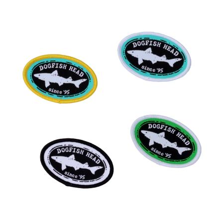 Close-up of four assorted color iron patches with classic Dogfish Head shark logo. 