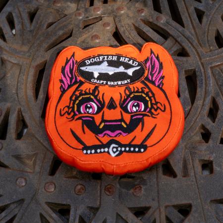 Orange punkin dog toy is in the shape of the artwork with the Dogfish Head shark and shield logo up top.