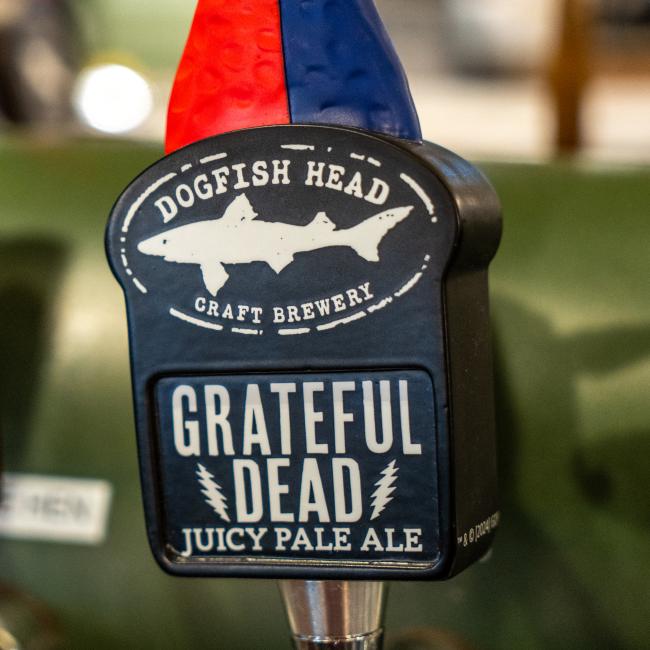 Dogfish Head Shark Tap handle close up of base featuring shark & sheild logo and Grateful Dead text
